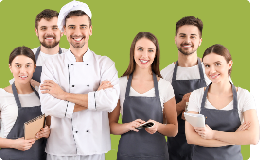 Un groupe de personnes souriant habillés en cuisinier